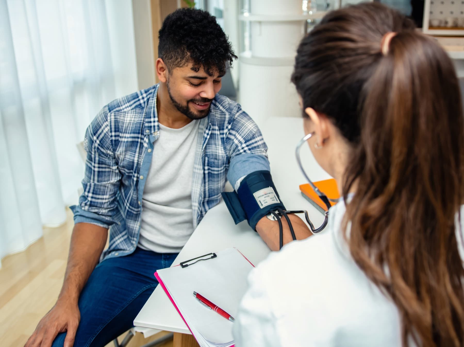 Provider checking a patient's blood pressure during an urgent care visit